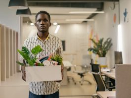 man leaving office with belongings in a box