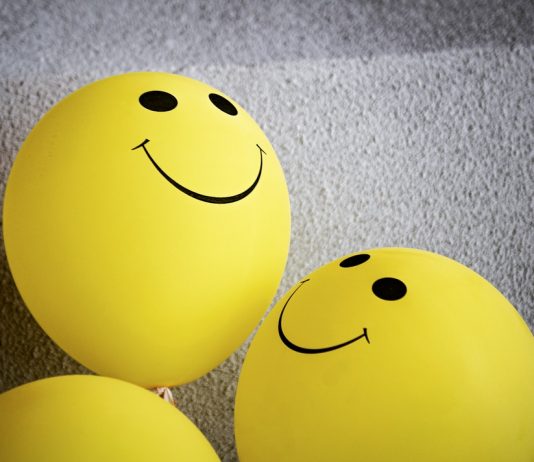 smiling faces on yellow balloons