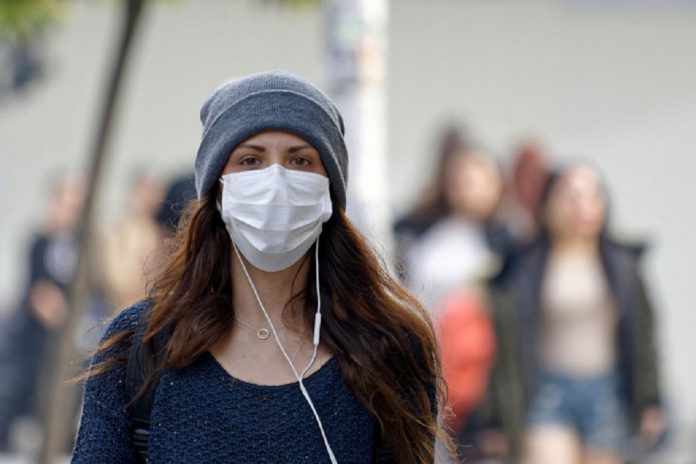 Woman wearing face mask on way to work