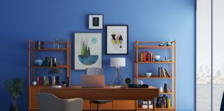 beautiful home office with blue wall and pictures