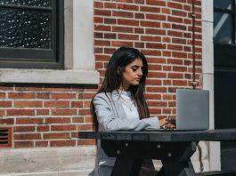 woman working remotely at laptop in city
