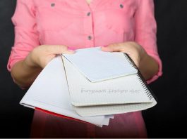 woman handing over notebooks