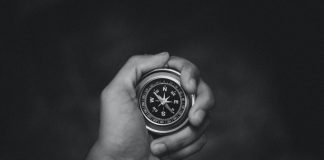 compass in hand in black and white image