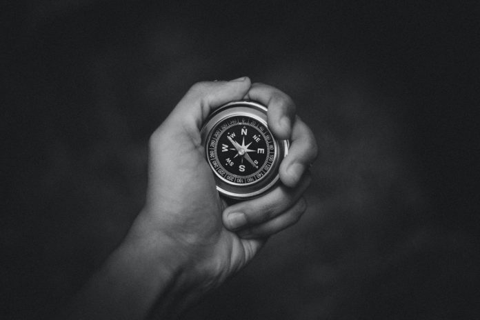 compass in hand in black and white image
