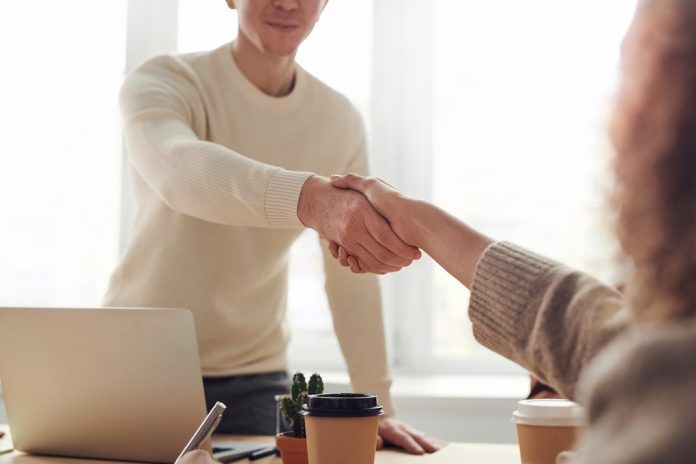 man and woman shaking hands after interview