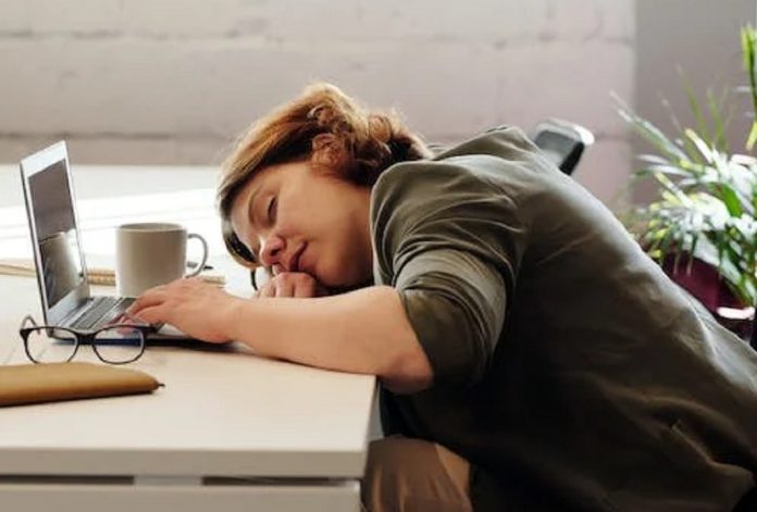 female employee asleep at her desk