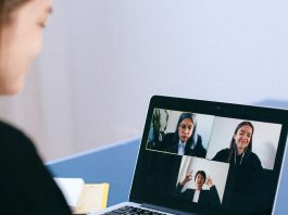 person taking part in online group call on laptop