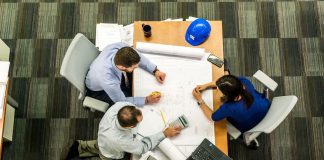 3 people reviewing plans at a table