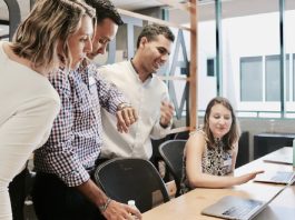 group of office workers discussing new software