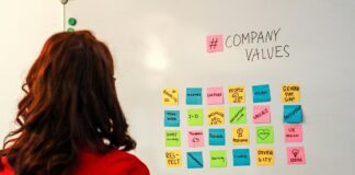 employee looking at white board with company values