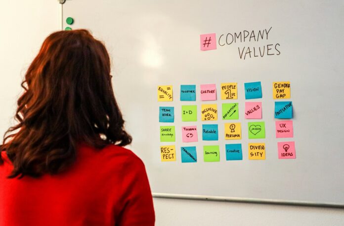 employee looking at white board with company values