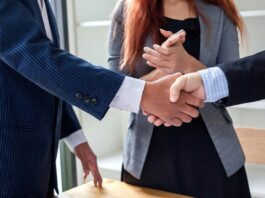 Work colleagues shaking hands